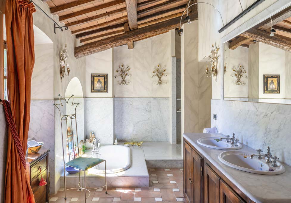 Bathroom with a large stained glass window featuring cherub designs
