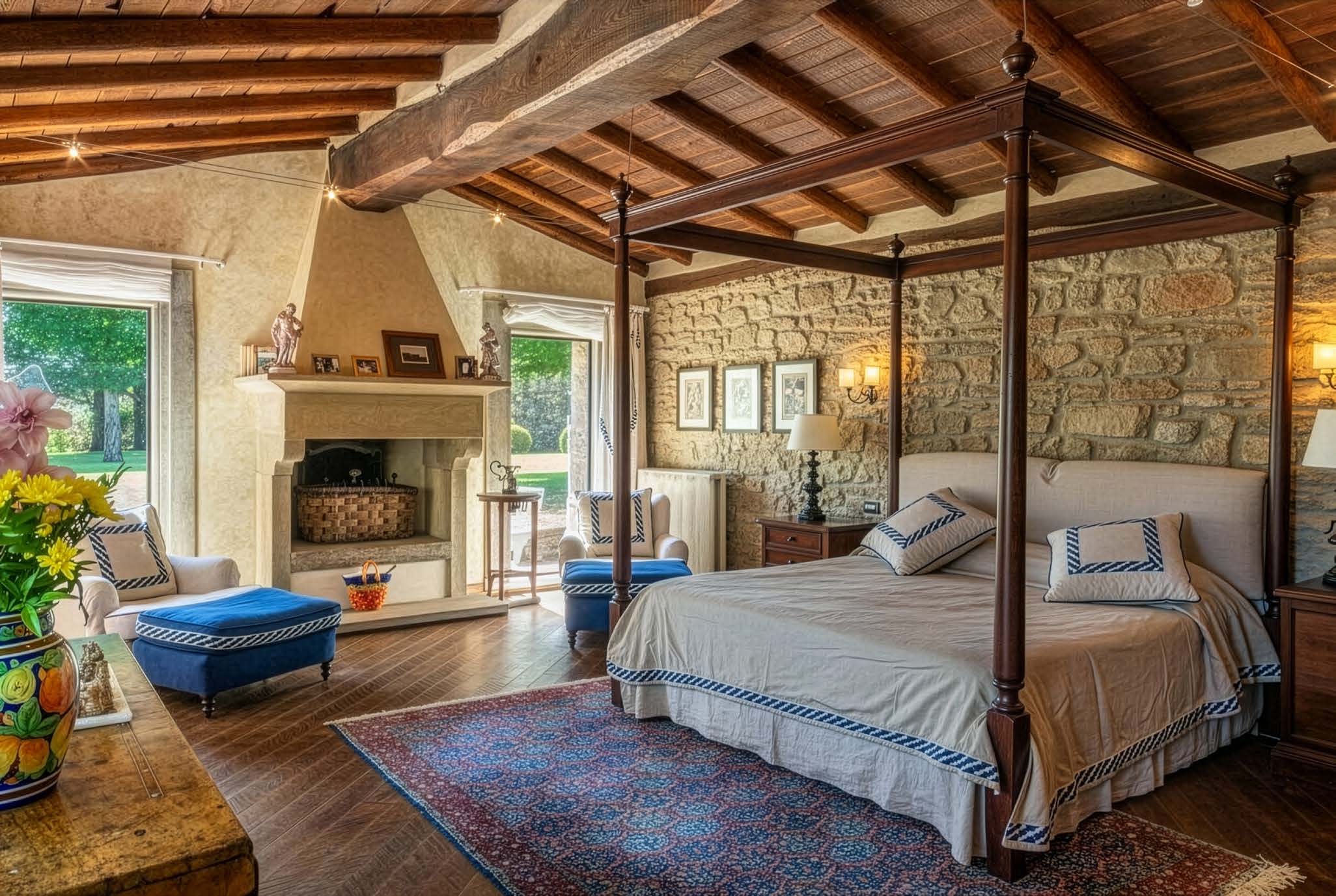 Rustic bedroom with a four-poster bed, stone walls and a wooden ceiling