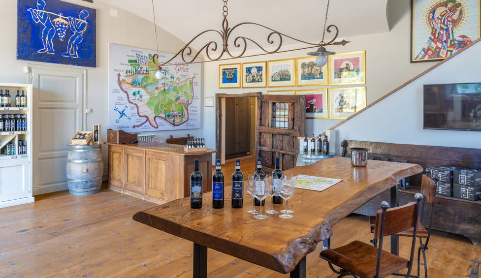 Pulled back view of the larger tasting and bottle room with artwork and map