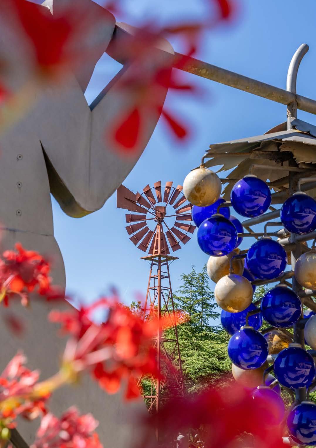 Artistic sculpture with blue and white spheres against a blue sky