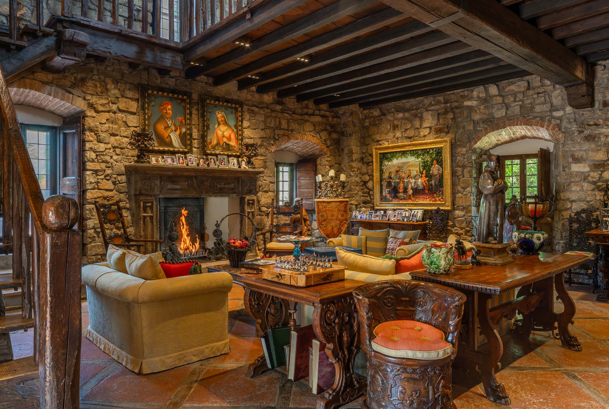 Rustic villa living room with stone walls, wooden beams and antique furniture